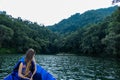 Pokhara - A woman sitting in a blue boat and enjoying the tour Royalty Free Stock Photo