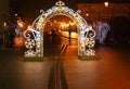 POLAND, BYDGOSZCZ - December 30, 2020: Christmas festive arch of garlands on street of the night New Year`s