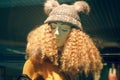 POLAND, BYDGOSZCZ - 15 february 2020: Funny mannequin in shop window. Female dummy with unruly curly hair and hat