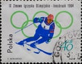 POLAND-CIRCA 1964 : A post stamp printed in Poland showing A downhill skier in front of the Olympic Rings Innsbruck 1964