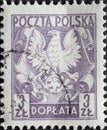 POLAND-CIRCA 1953 : A post stamp printed in Poland showing the heraldic animal of Poland the eagle on shield, circa