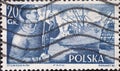 POLAND-CIRCA 1956 : A post stamp printed in Poland showing a portrait of a dock worker and the cargo ship Poko