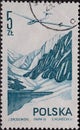 POLAND-CIRCA 1976 : A post stamp printed in Poland showing a glider over mountains and a mountain lake. Modern airflight Royalty Free Stock Photo