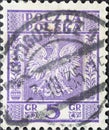 POLAND-CIRCA 1932 : A post stamp printed in Poland showing the heraldic animal of the eagle in the Coat of Arms of Poland - Vertic