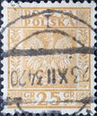 POLAND-CIRCA 1932 : A post stamp printed in Poland showing the heraldic animal of the eagle in the Coat of Arms of Poland - Vertic