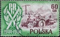 POLAND-CIRCA 1954 : A post stamp printed in Poland showing a historic tractor with a mower and overhead line. The 10th Anniversary