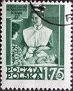 POLAND-CIRCA 1953 : A post stamp printed in Poland showing a historical picture of a pediatric nurse in uniform with a baby. Healt