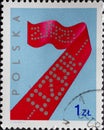 POLAND-CIRCA 1975 : A post stamp printed in Poland showing A punched tape with the code: The 7th Meeting of the Polish United Work