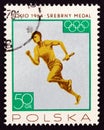 POLAND - CIRCA 1965: A stamp printed in Poland shows 4x100m relay men, silver medal, circa 1965.