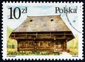 POLAND - CIRCA 1986: A stamp printed in Poland shows 19th-century Oravian cottage, Zubrzyca Gorna, circa 1986.