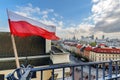 Poland Flag in Blue Sky and Warsaw in background Royalty Free Stock Photo