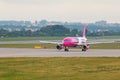 Aircraft line Wizzair taxiing on the airport runway.