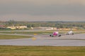 Aircraft line Wizzair taxiing on the airport runway.