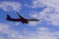 Poland,Krakow 08.11.2019: Wizzair aircraft close-up landing against blue sky and white clouds. air traffic safety, sky, aircraft
