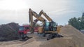 Poland Ostrowiec Swietokrzyski October 11, 2023 at 12:55. Two Caterpillar excavators on a gravel pile at a construction site.