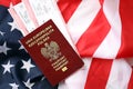 Poland passport with airline tickets on American US flag close up. Tourism and travel Royalty Free Stock Photo