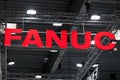 A Fanuc company logo on the wall. Fanuc provides automation products and services such as robotics and computer numerical control Royalty Free Stock Photo