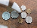 Poland\'s currency, zloty and groszy, under magnifying glass on the wooden table. Local European currencies