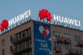 The huawei logo illuminated in the evening time