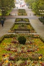 Beautiful and colorful well-kept spa park with old trees, flower beds, a fountain and a Royalty Free Stock Photo