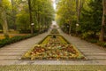 Beautiful and colorful well-kept spa park with old trees, flower beds, a fountain and a Royalty Free Stock Photo