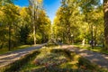 Beautiful and colorful well-kept spa park with old trees, flower beds, a fountain and a Royalty Free Stock Photo