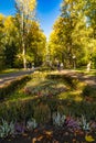 Beautiful and colorful well-kept spa park with old trees, flower beds, a fountain and a Royalty Free Stock Photo