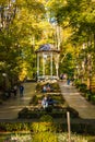 Beautiful and colorful well-kept spa park with old trees, flower beds, a fountain and a Royalty Free Stock Photo