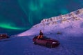 The polar arctic man Northern lights aurora borealis sky star in Norway Svalbard in Longyearbyen city moon mountains Royalty Free Stock Photo