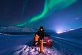 The polar arctic man Northern lights aurora borealis sky star in Norway Svalbard in Longyearbyen city moon mountains Royalty Free Stock Photo