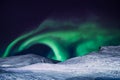 The polar arctic Northern lights aurora borealis sky star in Norway Svalbard in Longyearbyen city moon mountains Royalty Free Stock Photo