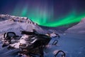 The polar arctic Northern lights aurora borealis sky star in Norway Svalbard Longyearbyen city snowscooter mountains Royalty Free Stock Photo