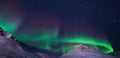 The polar arctic Northern lights aurora borealis sky star in Norway Svalbard Longyearbyen city snowscooter mountains
