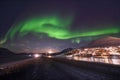 Polar arctic Northern lights aurora borealis sky star in Norway Svalbard in Longyearbyen city travel mountains