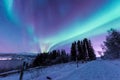 Polar arctic Northern lights aurora borealis sky star in Scandinavia Norway Tromso in the farm winter snow mountains Royalty Free Stock Photo