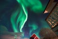 Polar arctic Northern lights aurora borealis sky star in Scandinavia Norway Tromso in the farm winter snow mountains Royalty Free Stock Photo