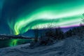 Polar arctic Northern lights aurora borealis sky star in Scandinavia Norway Tromso in the farm winter snow mountains Royalty Free Stock Photo