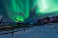 Polar arctic Northern lights aurora borealis sky star in Scandinavia Norway Tromso in the farm winter snow mountains Royalty Free Stock Photo