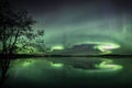 Polar Aurora lights in the starry sky over the lake in the  forest in Poytya, Finland Royalty Free Stock Photo