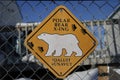 Polar Bear crossing sign on a fence