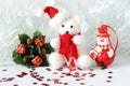 Polar bear wearing a hat and a blue scarf posed next to gifts with shiny knots on a Christmas holiday decor