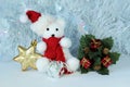 Polar bear wearing a hat and a red scarf posed next to gifts with shiny knots on a Christmas holiday decor