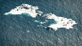 Polar bears on melting ice rocks in ocean. Aerial composition.