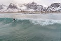 Polar circle surfing in Norway in Flakstad , winter time with freezing whether