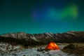 Polar Night landscape with illuminated tent and Polar Lights Royalty Free Stock Photo