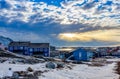 Polar sunset over Inuit houses on the rocky hills with snow, Nuuk city, Greenland Royalty Free Stock Photo