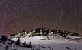 Polaris and star trails over mountain