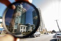 Polarizing filter held in front of a camera lens