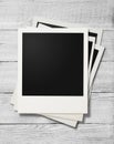 Polaroid photo frames on white wooden background Royalty Free Stock Photo