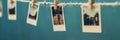 Polaroid photos attached to a string with clothespins creating a nostalgic display in a creative space. Generative AI Royalty Free Stock Photo